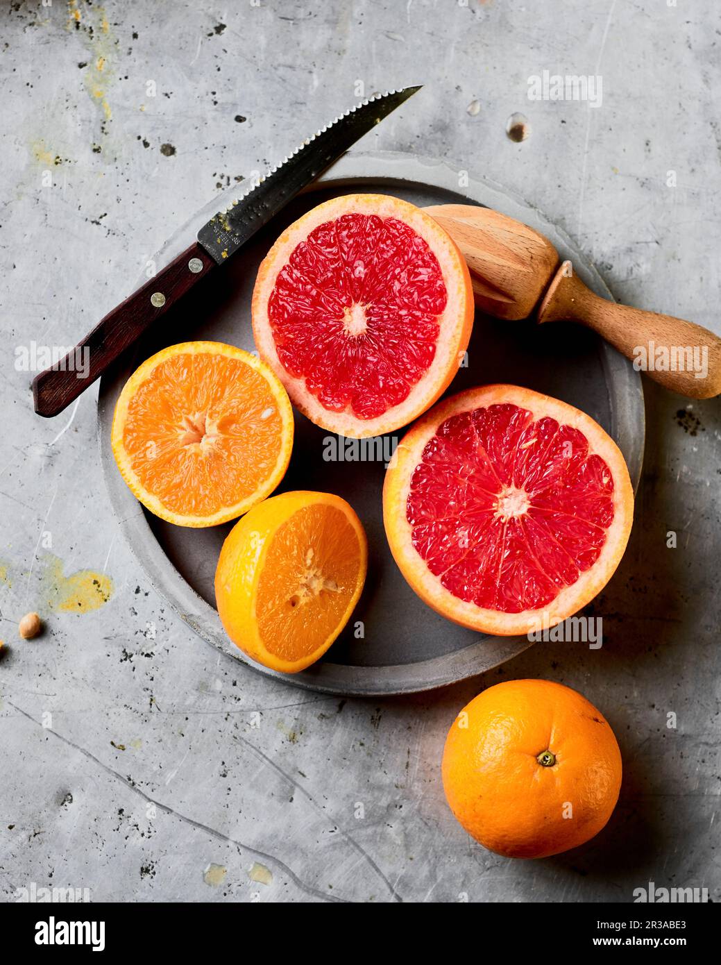 Freshly cut oranges ready to be squeezed Stock Photo