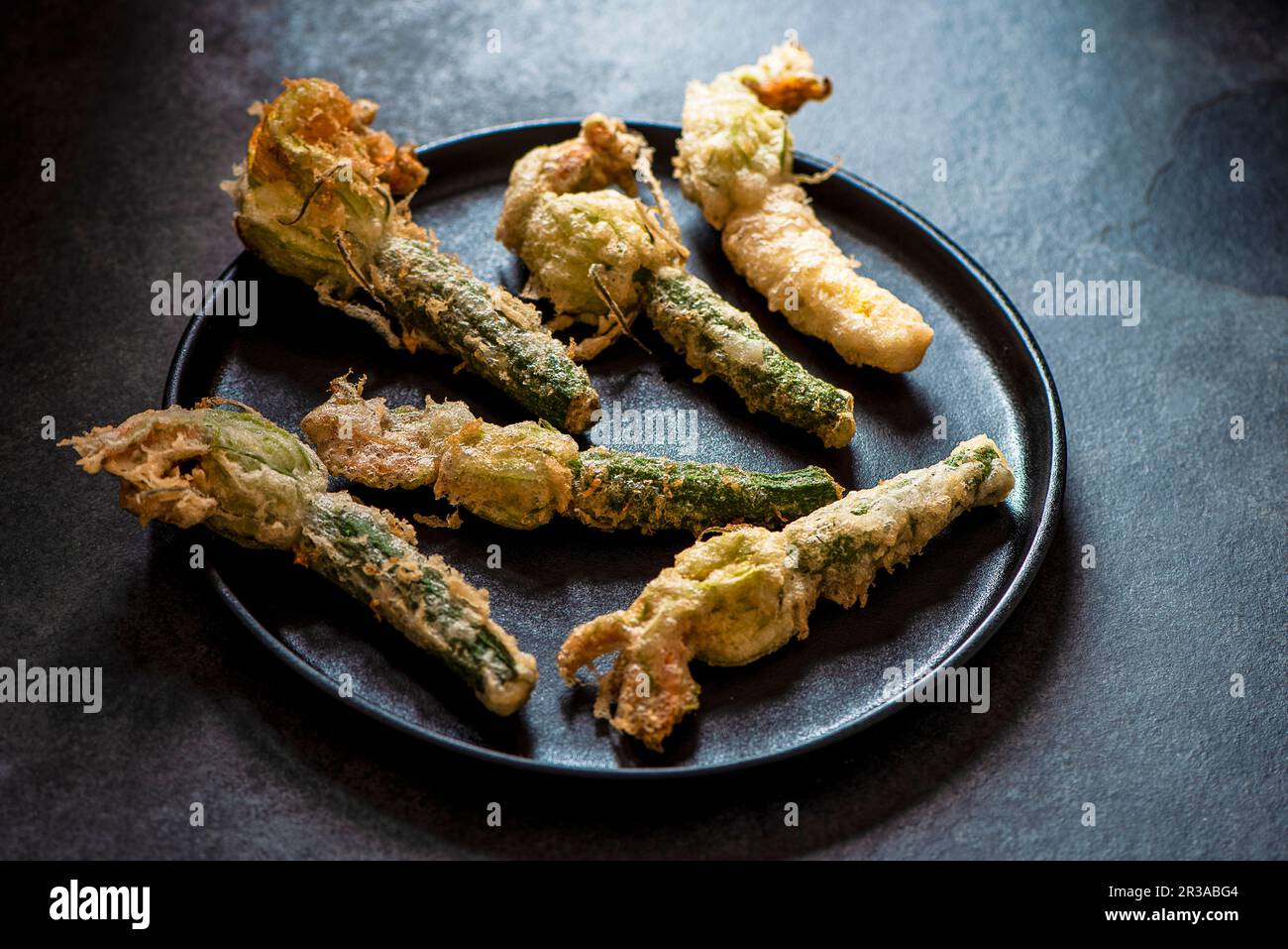 Young courgette with flowers in tempura batter Stock Photo Alamy