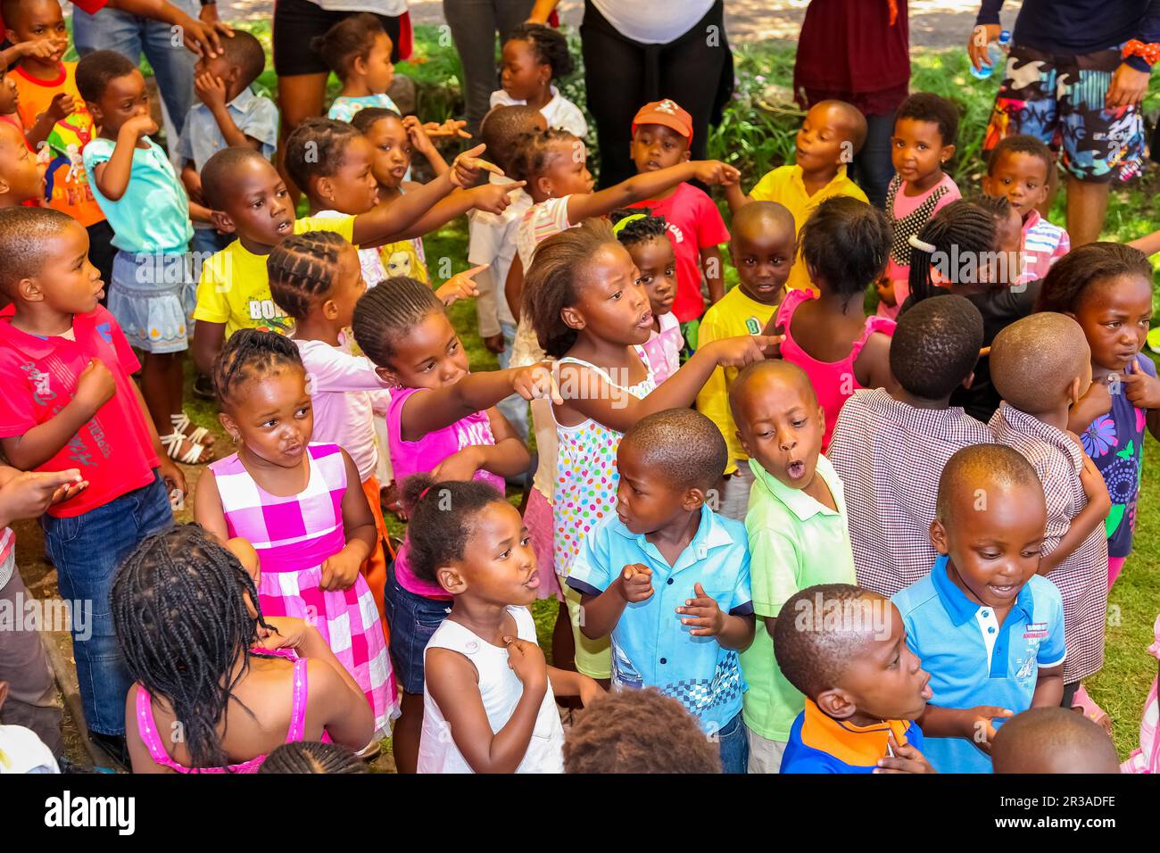 Young African Preschool kids singing songs in the playground of a kindergarten school Stock Photo