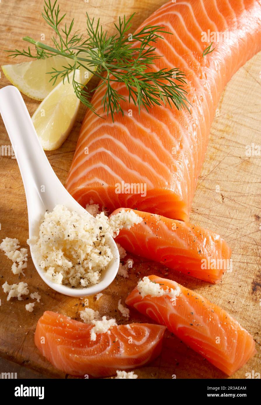 Smoked salmon fillet on a wooden board with horseradish Stock Photo - Alamy