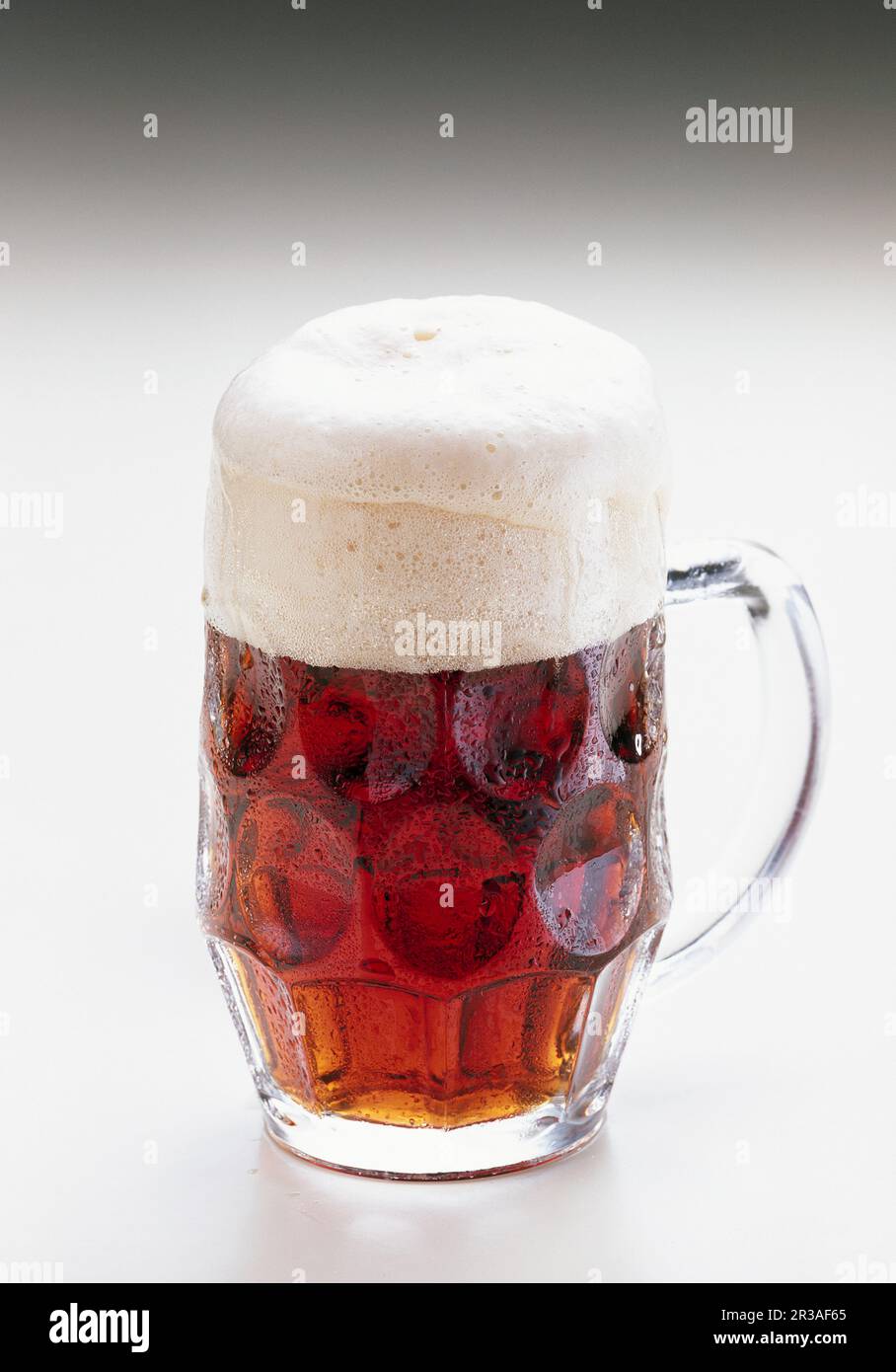Dark strong beer in a glass jug (bock beer Stock Photo Alamy