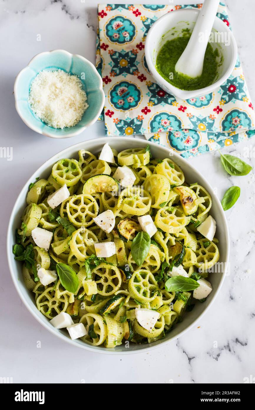 Ruote pasta salad with zucchini pesto and mozzarella Stock Photo