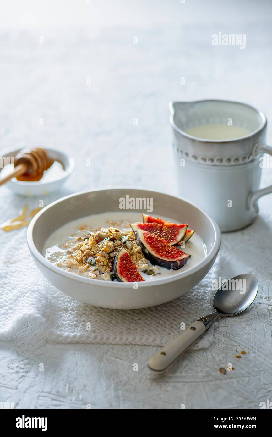 Overnight soaked oats with seeds, honey and fresh figs Stock Photo