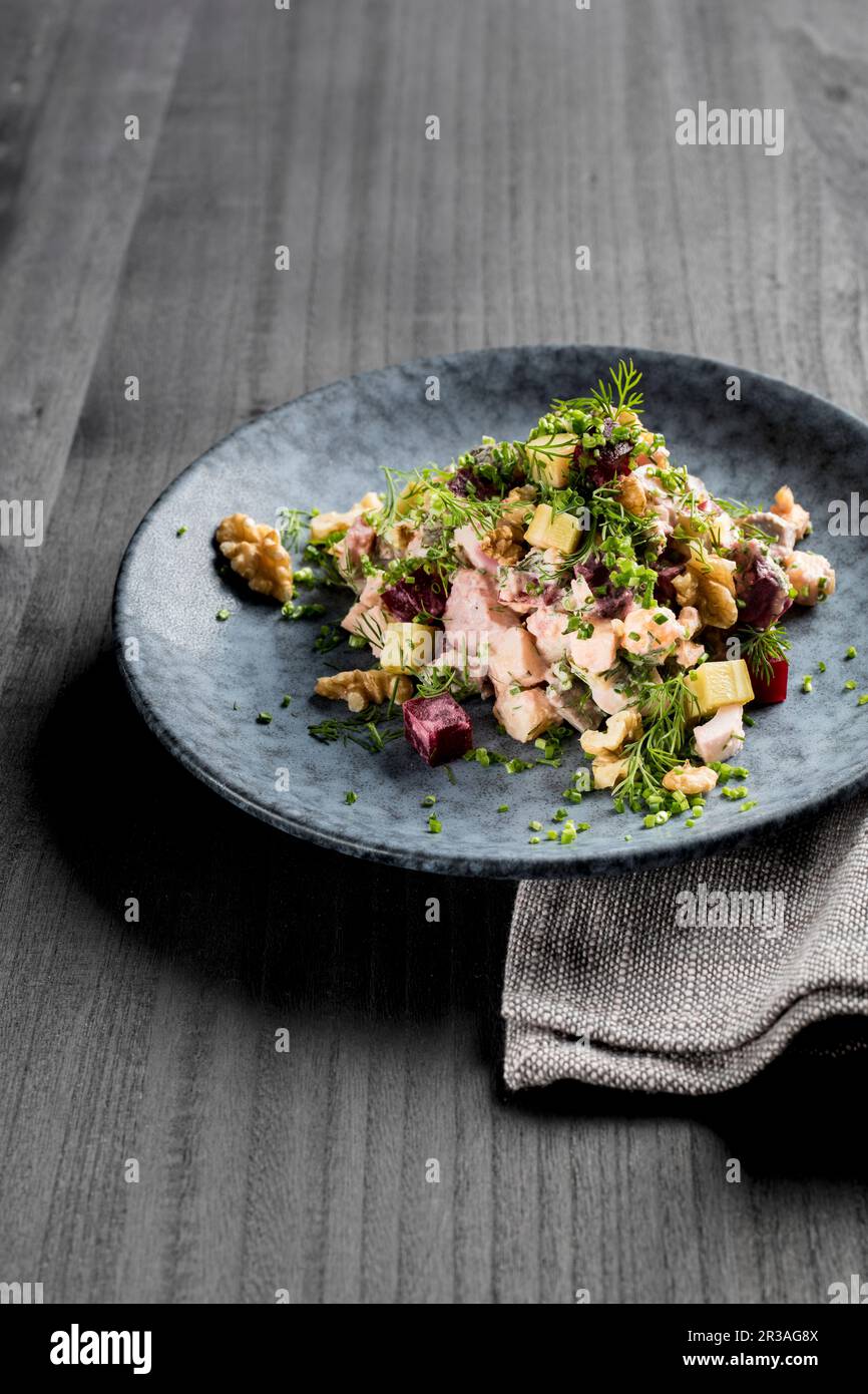 Herring salad with beef, beetroot, walnut, gherkins, dill, chive and apple Stock Photo