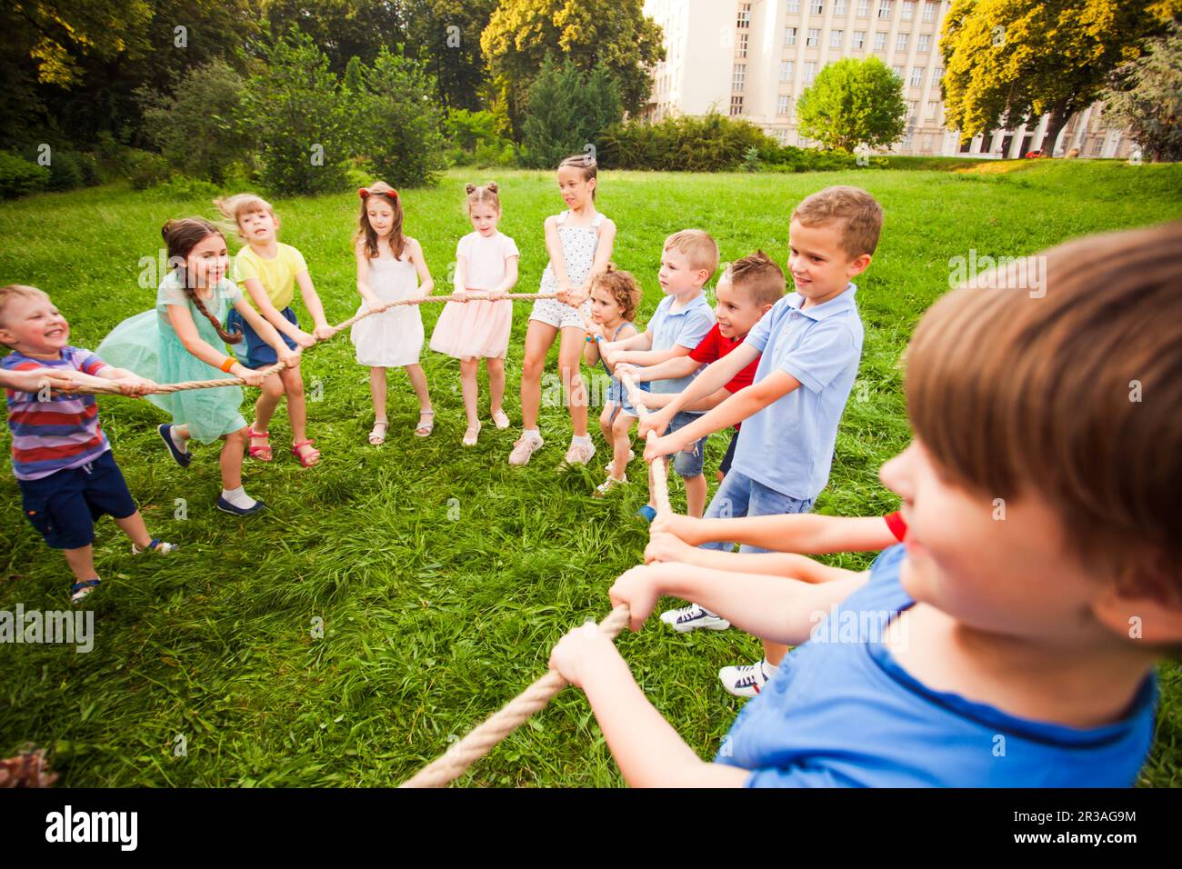 Children play with a rope in the park Stock Photo