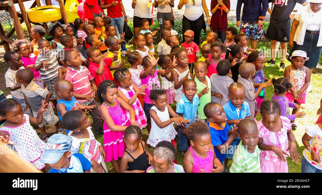 Young African Preschool kids singing songs in the playground of a kindergarten school Stock Photo