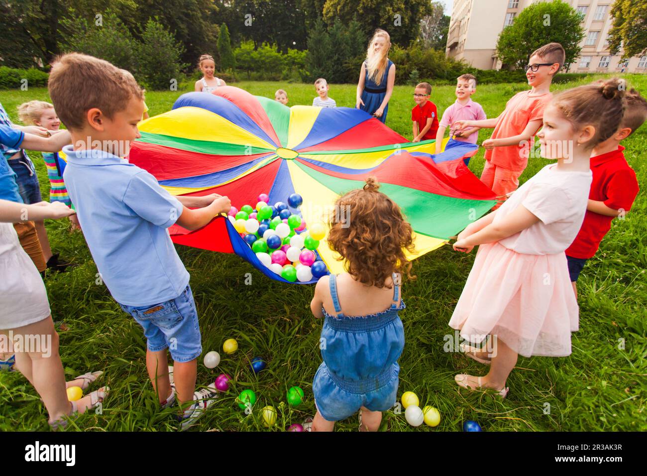 Cheerful children playing outdoors at birthday party Stock Photo