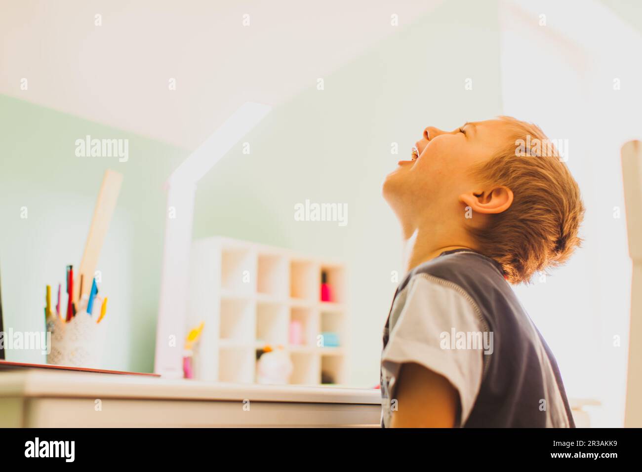 The boy doesn't want to study online at home Stock Photo