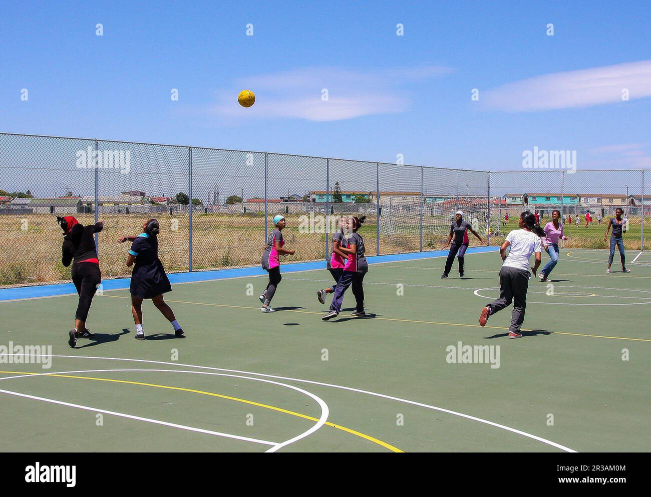 Diverse children playing Netball at school Stock Photo