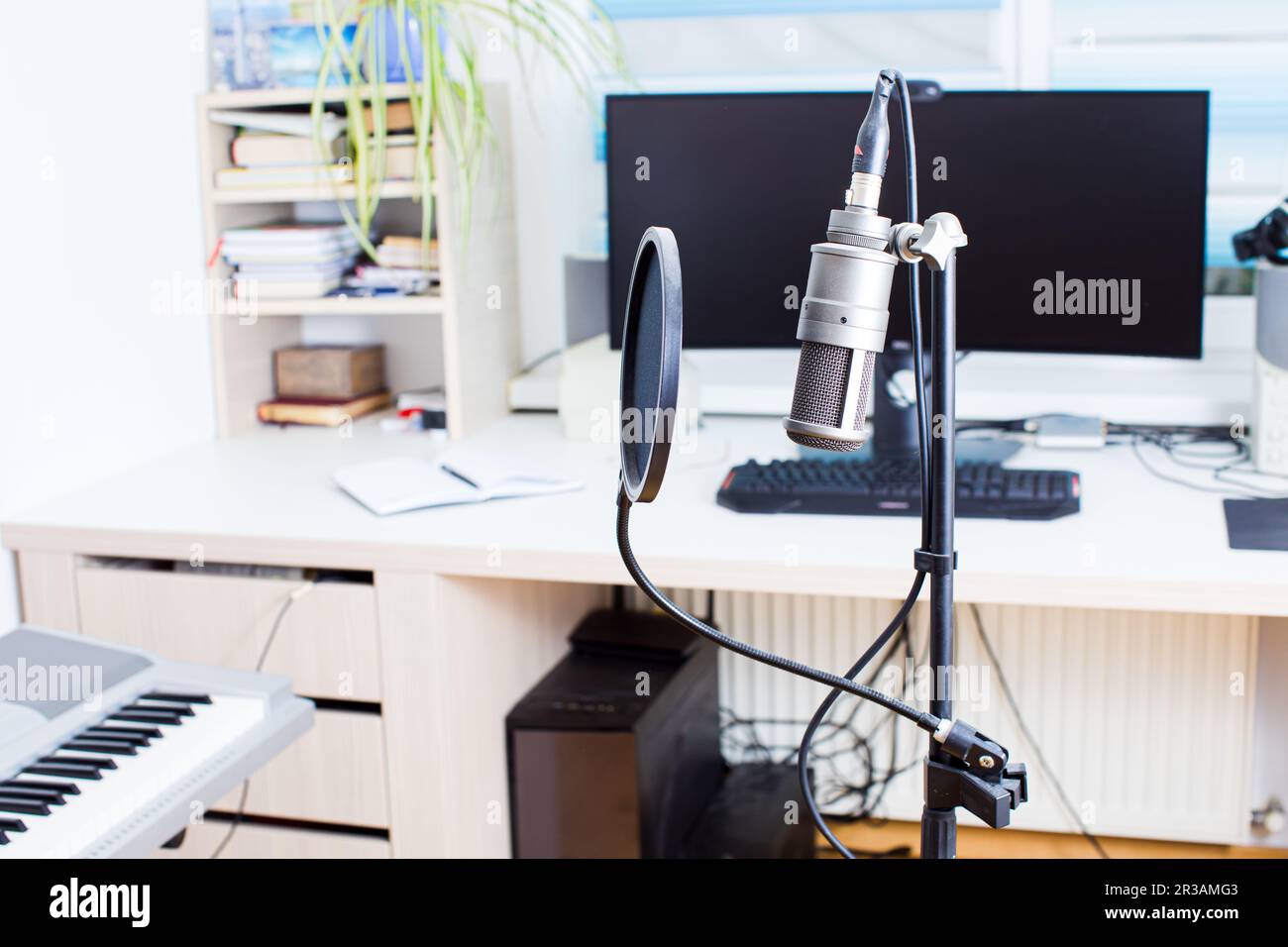 Music studio full of instruments and pc display Stock Photo - Alamy