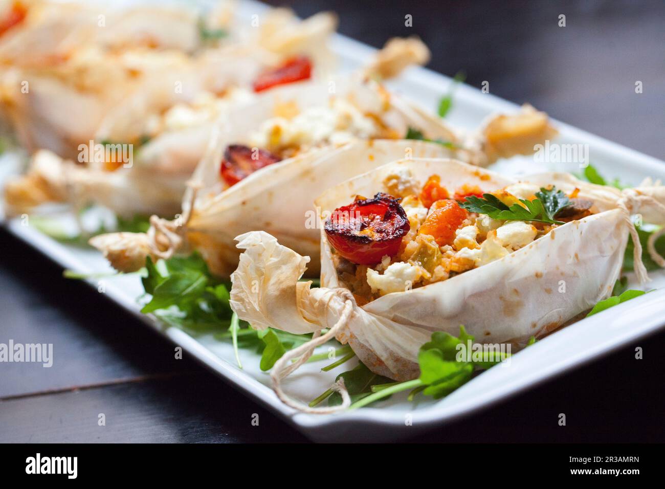 Pergament nests with tomatoes and cheese Stock Photo