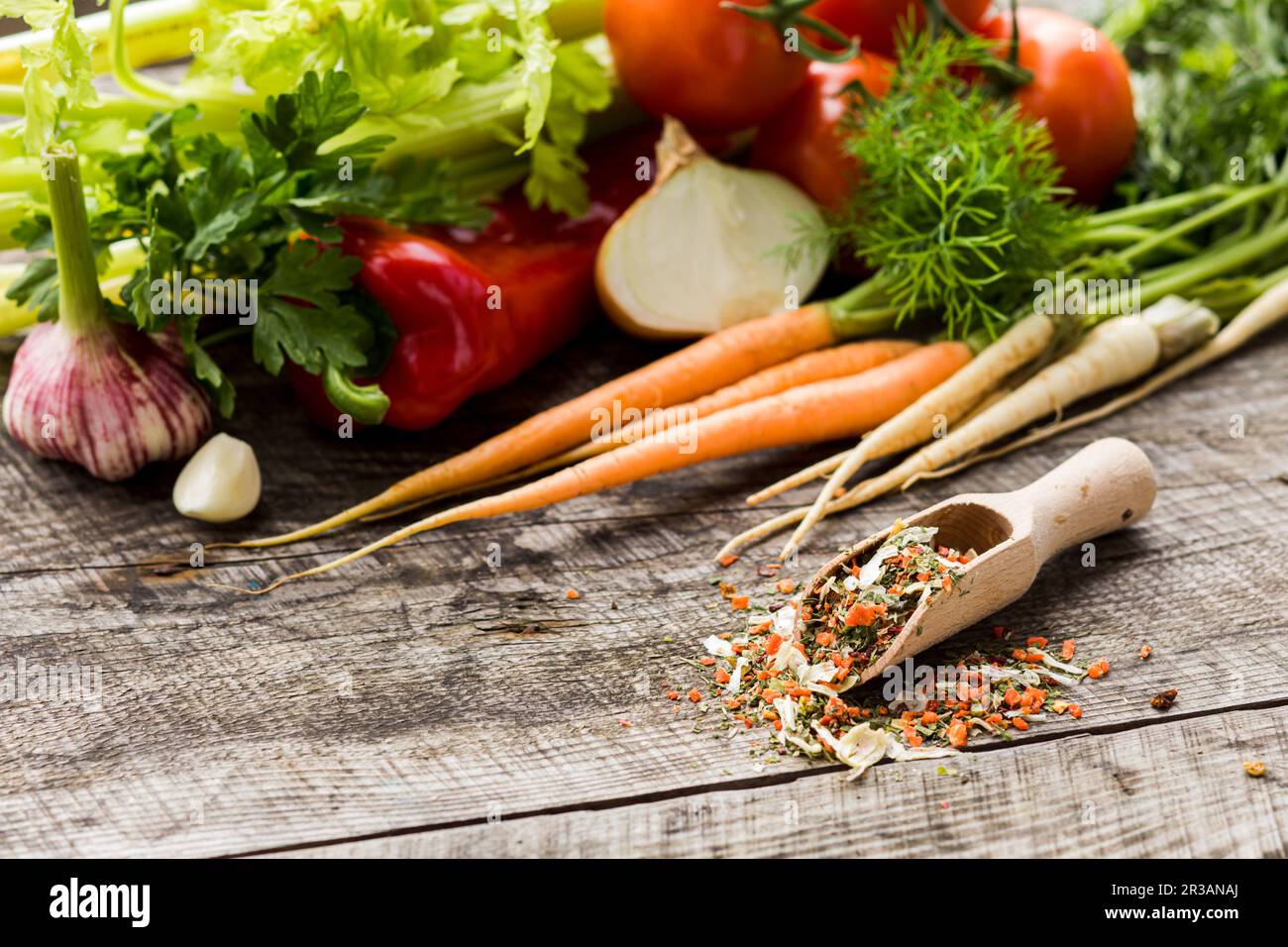 Wooden scoop with mix of dry vegetables, ground Stock Photo