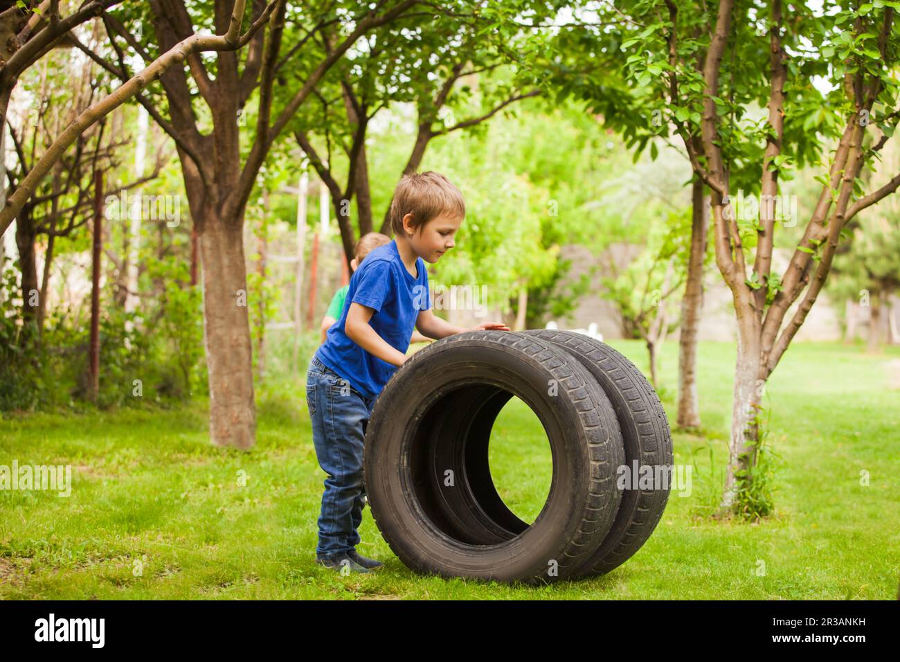 The preschool boys get acquainted with car parts Stock Photo