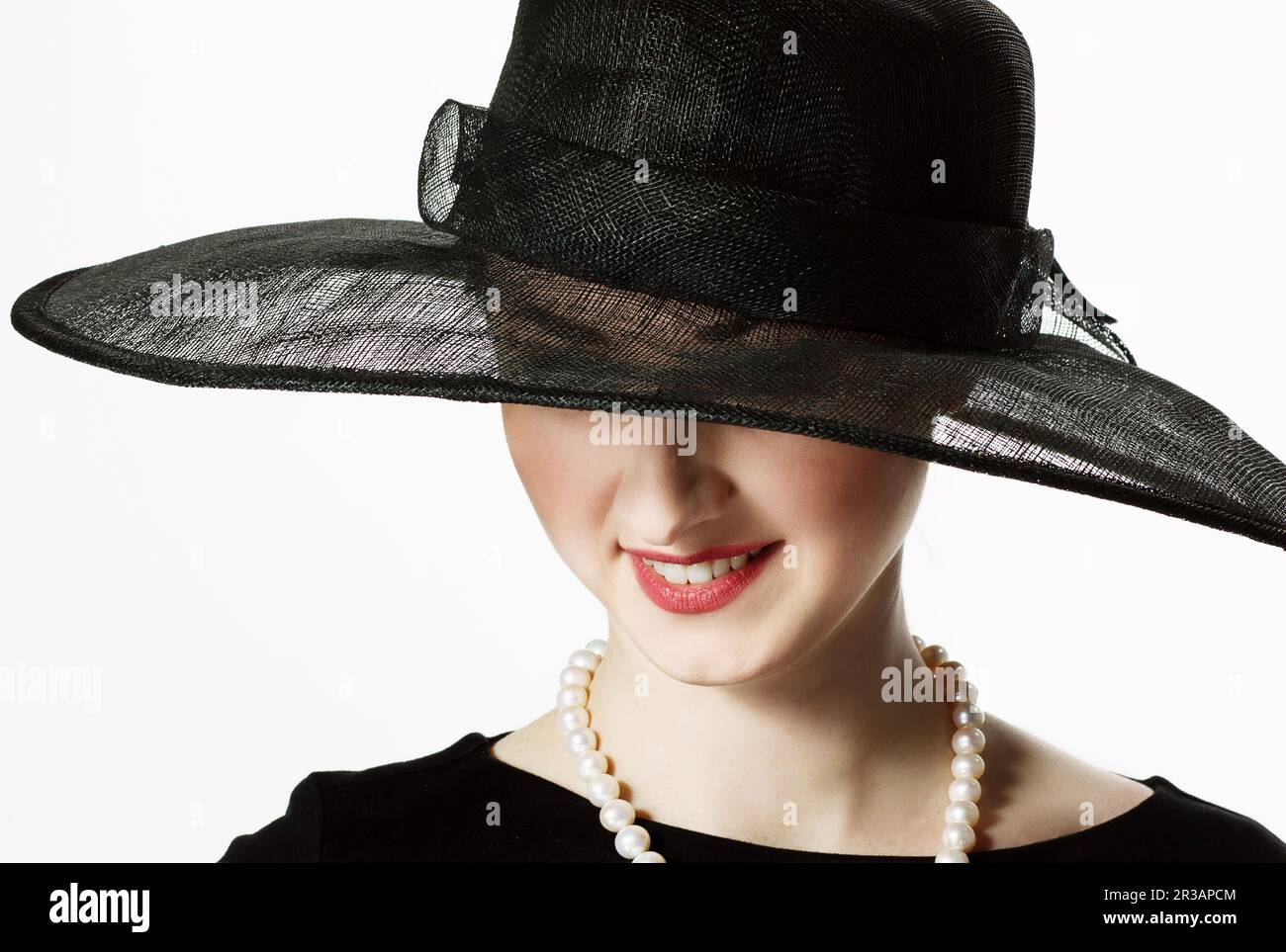 Close-up portrait of a beautiful woman in a black hat in retro style on ...