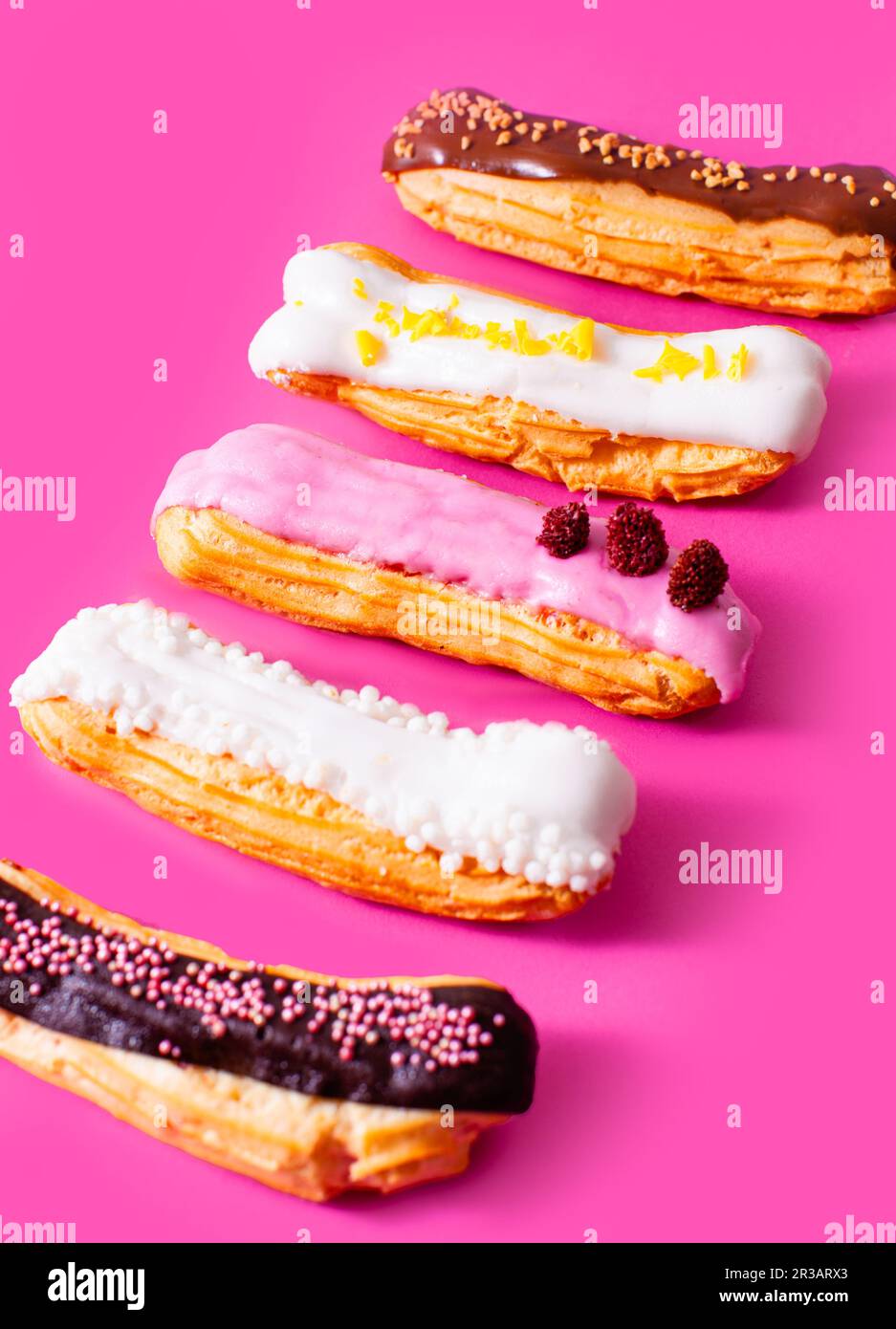 The set of colorful and delicious eclairs with many flavors Stock Photo
