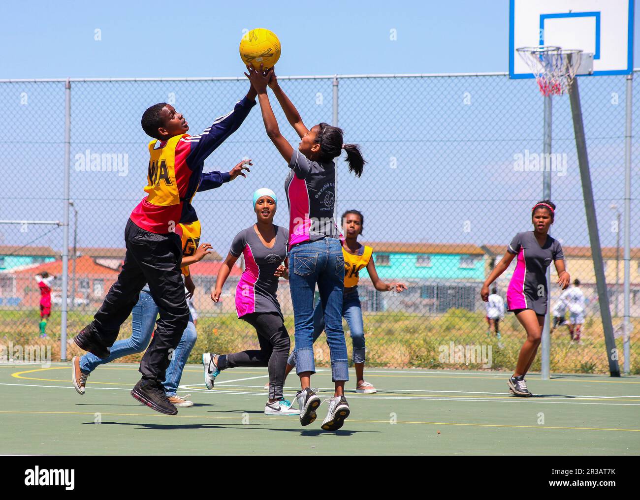 Diverse children playing Netball at school Stock Photo
