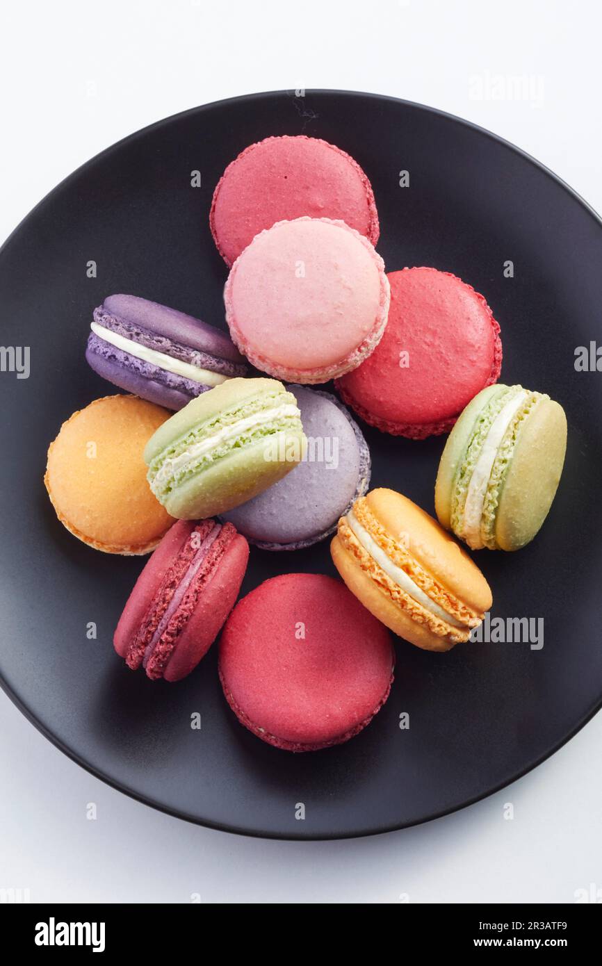 Macarons on a black plate Stock Photo