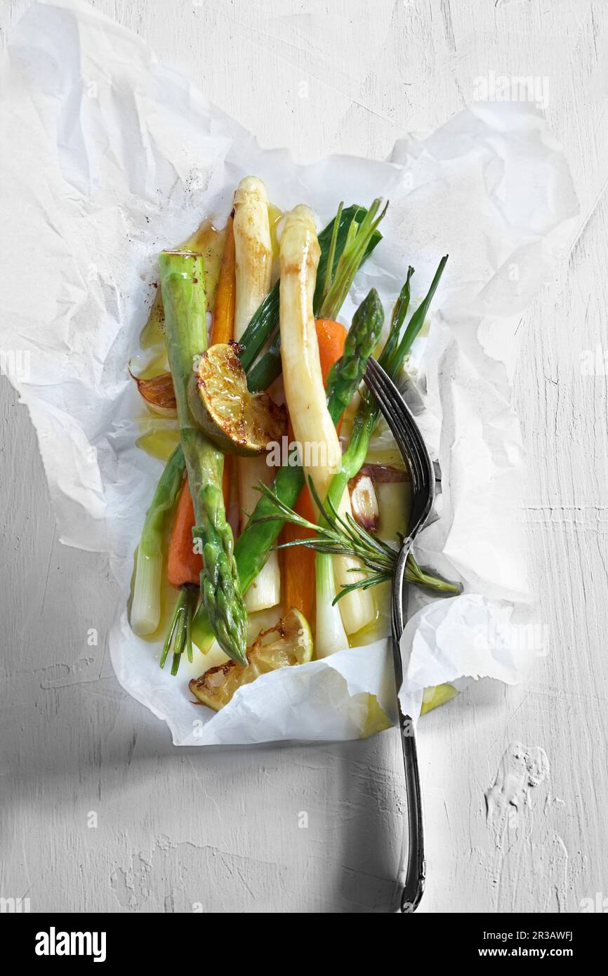Vegetables in parchment paper with rosemary and limes Stock Photo Alamy