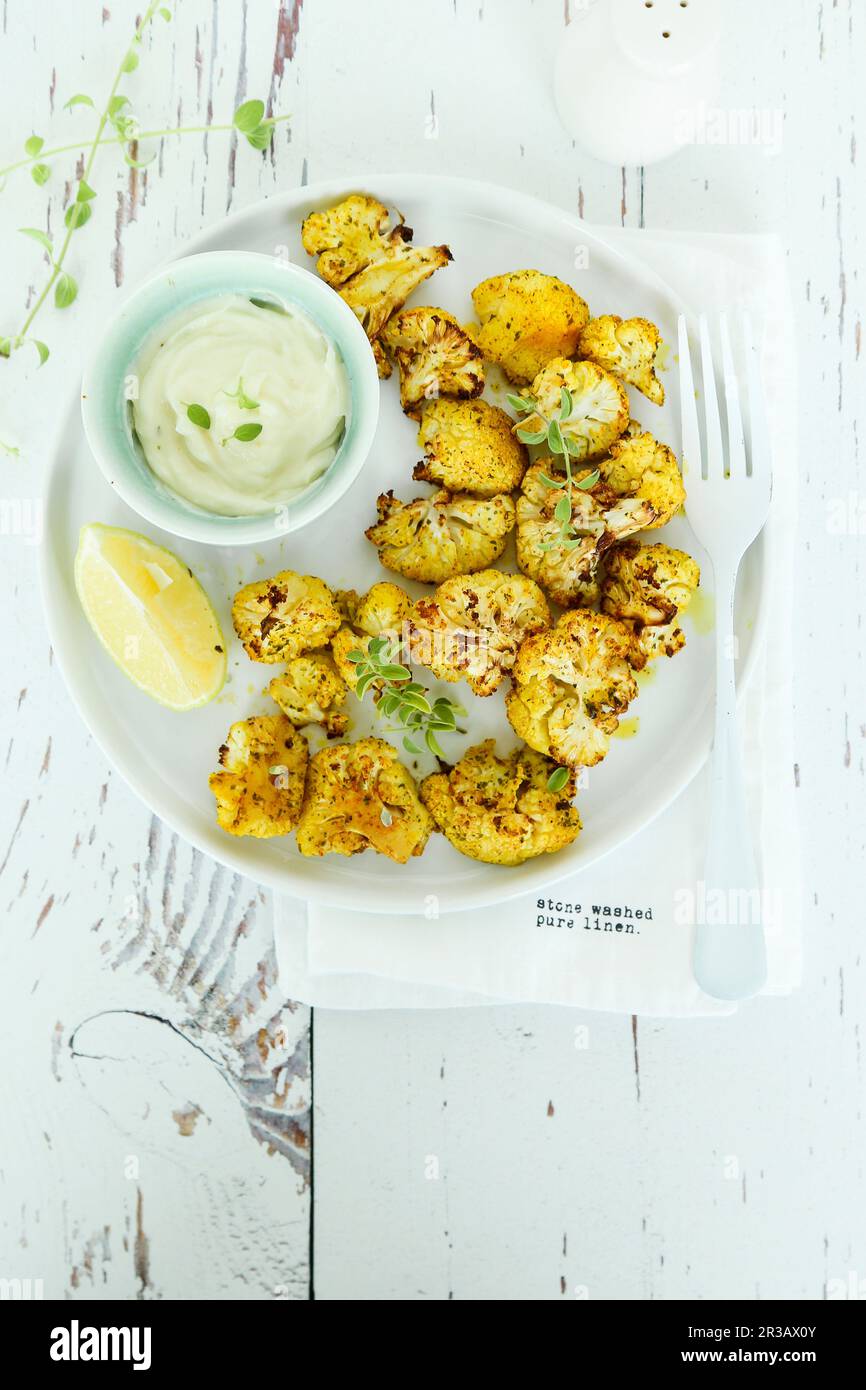 Roasted spiced cauliflower with yogurt sauce Stock Photo Alamy