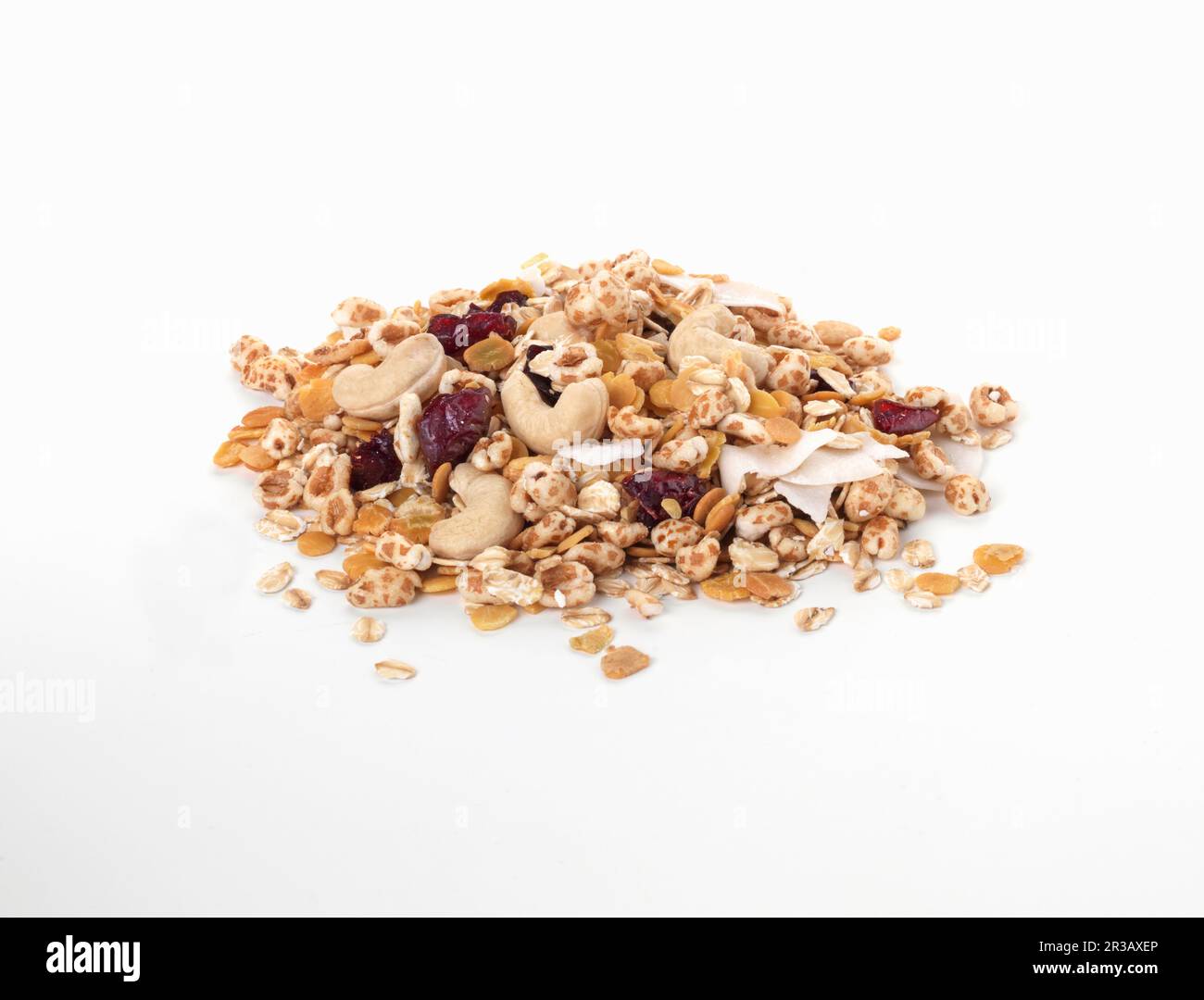 A pile of muesli with dried fruit and nuts on a white background Stock