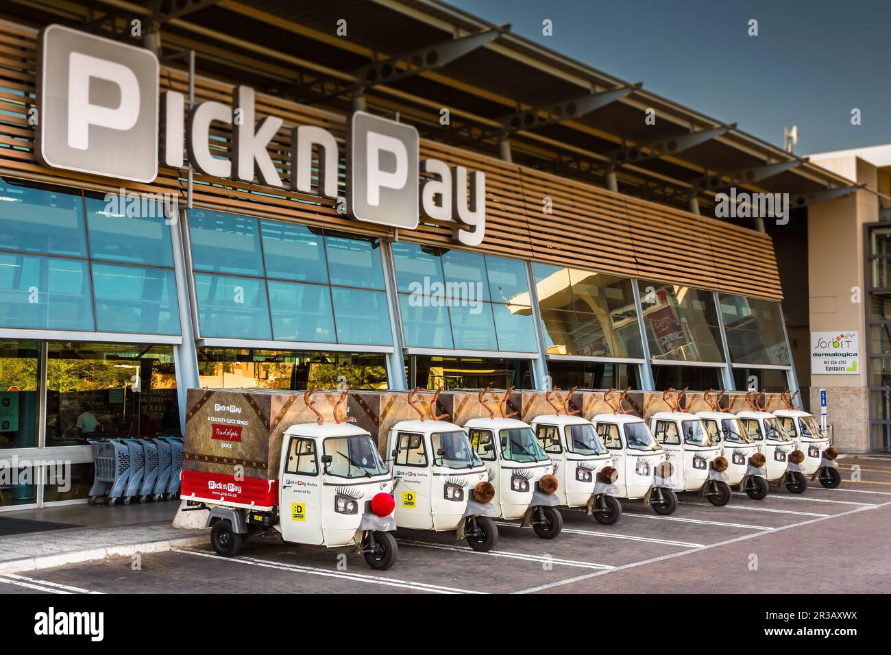 Small TukTuk Grocery Store Home Delivery Vehicles lined up at a supermarket Stock Photo