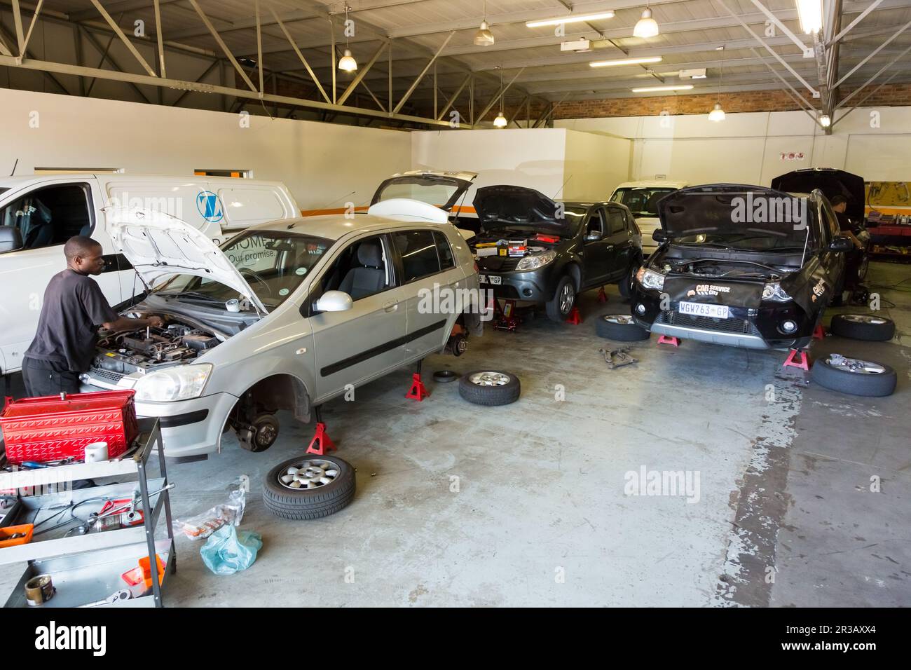 Mechanics in Car Service City repairing and diagnosing motor