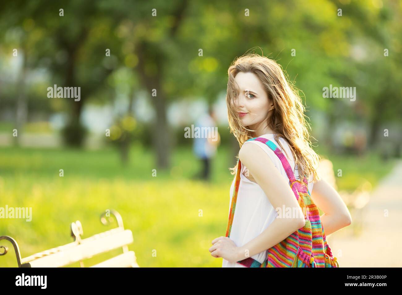 Portrait of lovely urban girl with backpack in the street. Happy smiling woman. Fashionable blonde g Stock Photo