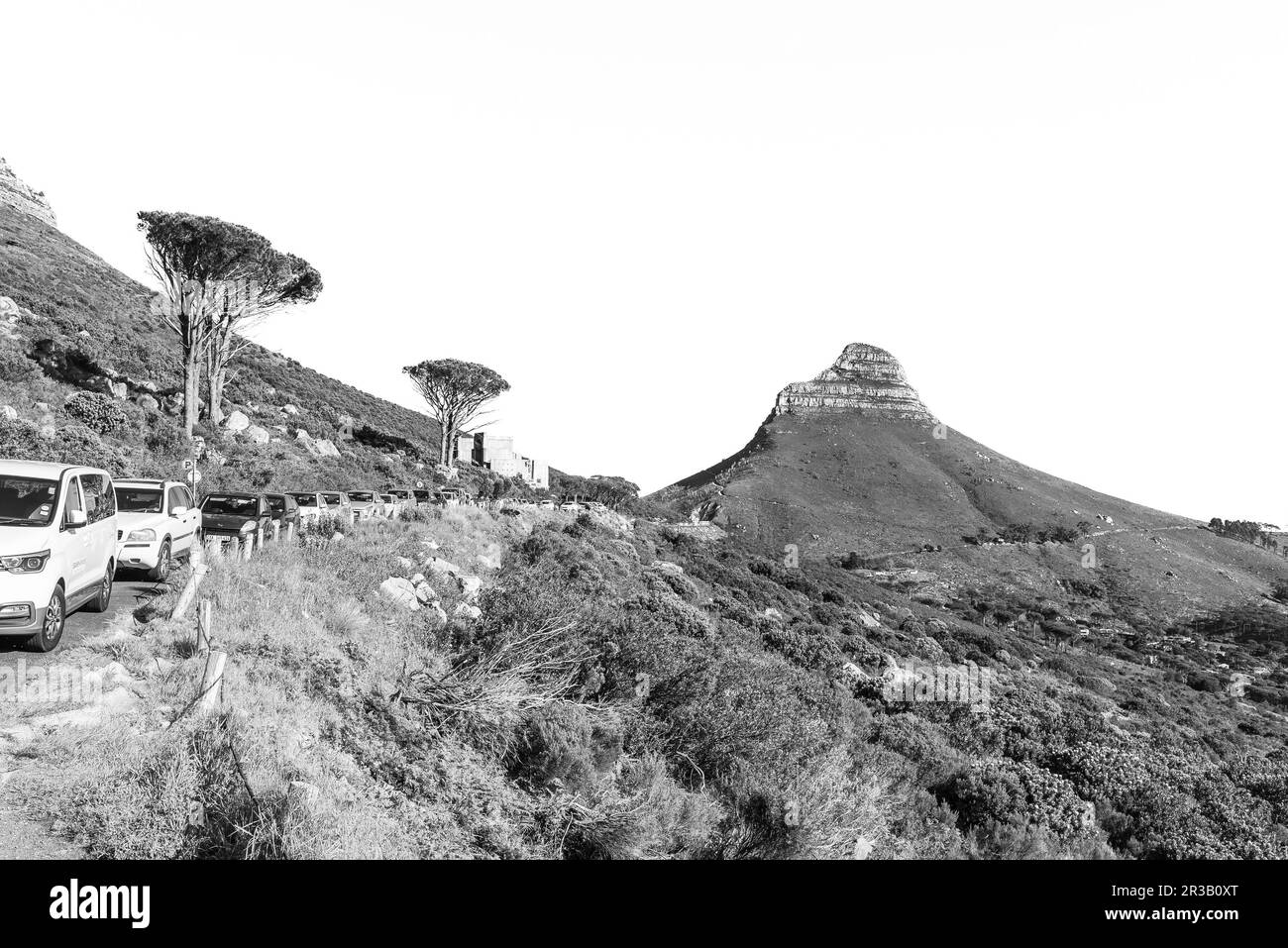 Cape Town, South Africa - Sep 14, 2022: Lions Head, the lower cable station and parked cars on the slope of Table Mountain in Cape Town. Monochrome Stock Photo