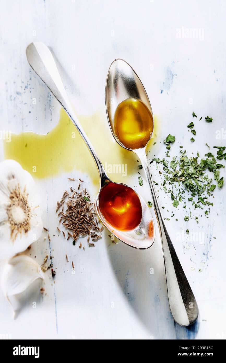 Different types of oil on two spoons Stock Photo Alamy
