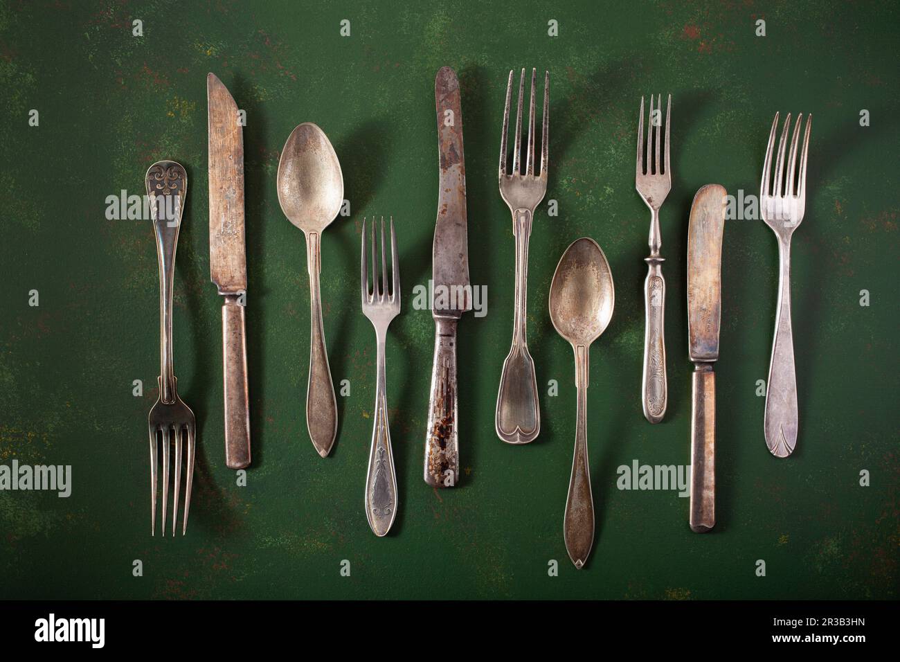 Vintage cutlery on a green surface Stock Photo