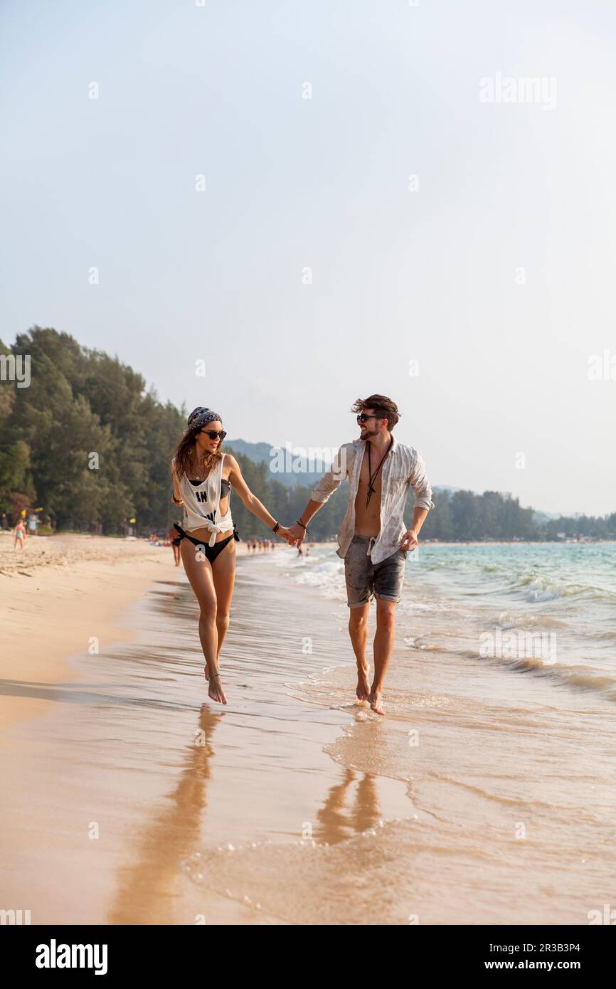 Couple holding hands walking hi-res stock photography and images - Alamy