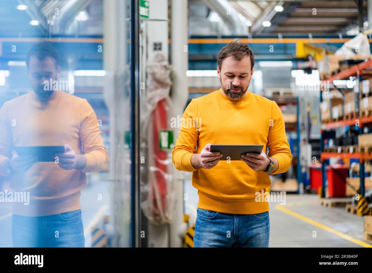 Mature manager using tablet PC in industry Stock Photo