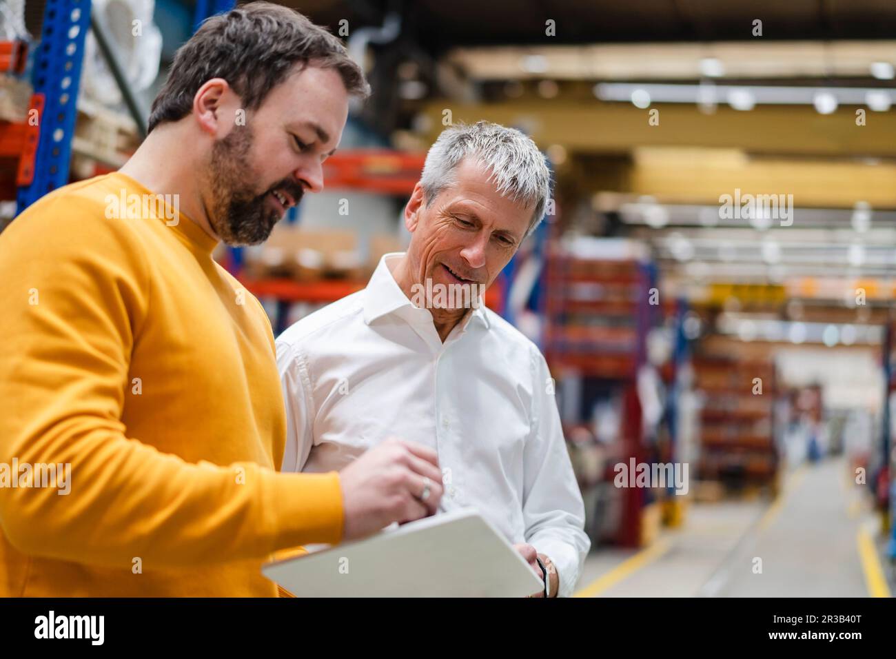 Businessmen having discussion over tablet PC Stock Photo