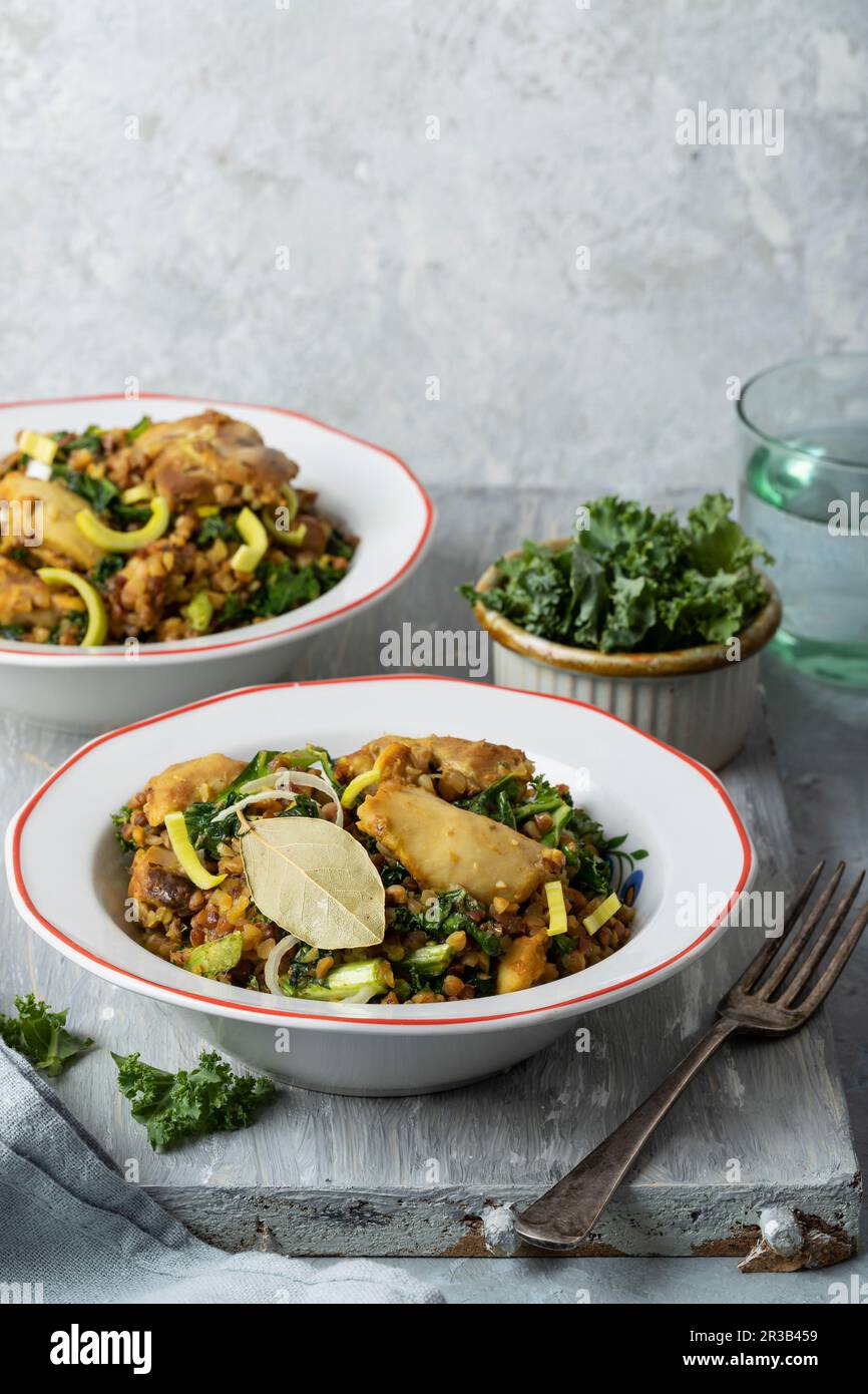 Polish buckwheat risotto with chicken thighs, leek and kale Stock Photo