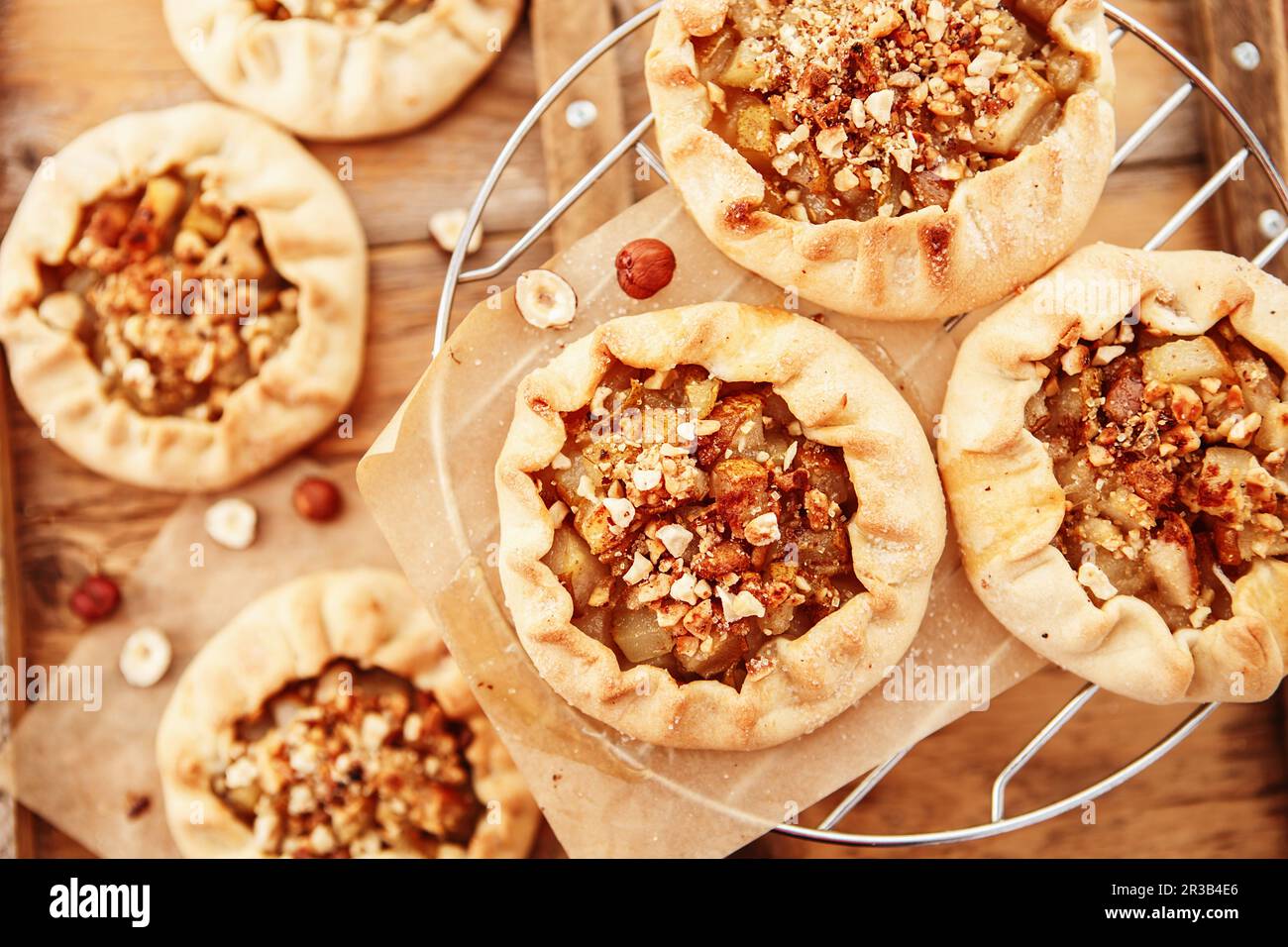 Caramelized pear rustic pie on wooden background, top view. Simple delicious dessert Stock Photo