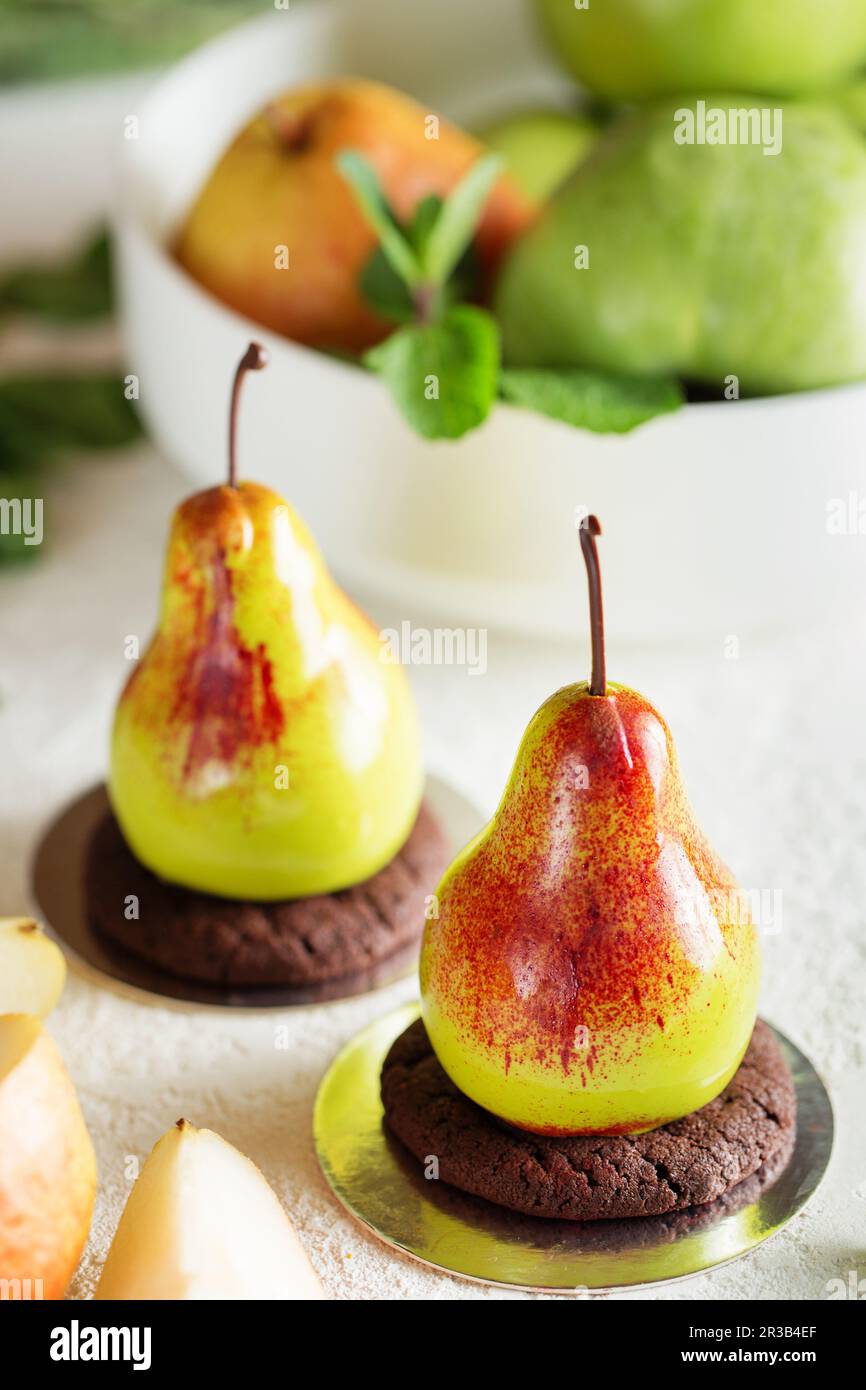 Mousse dessert in the shape of a pear fruit. Mousse cake Stock Photo