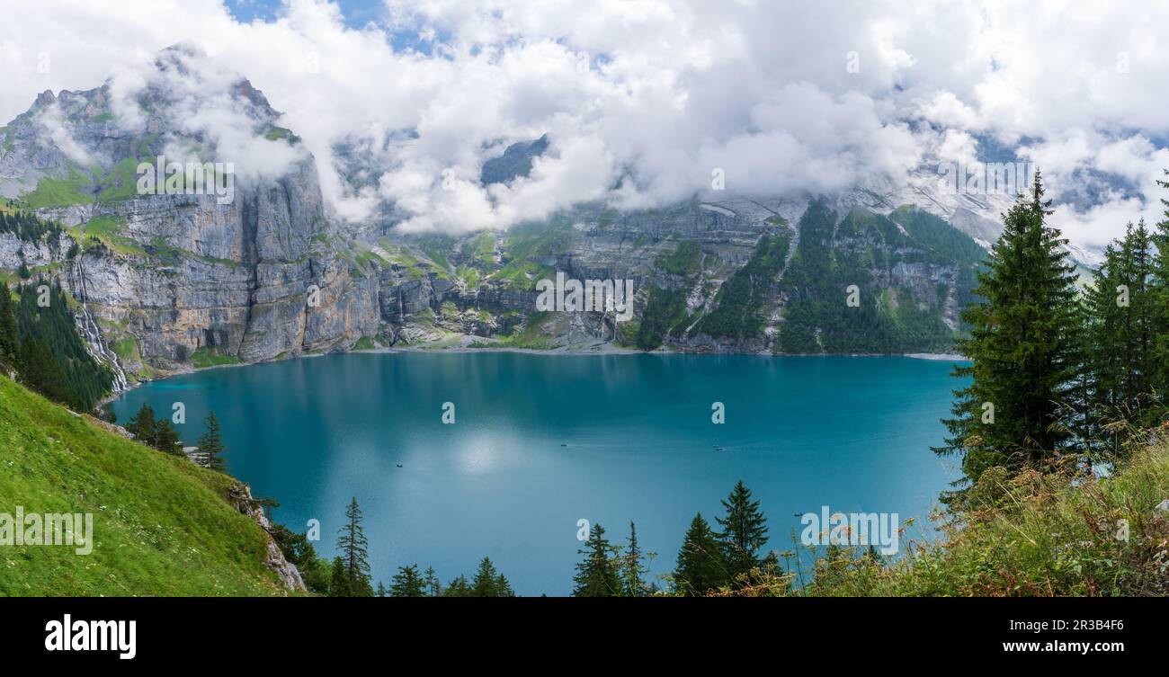 Amazing tourquise Oeschinnensee with waterfalls and Swiss Alps, Kandersteg, Berner Oberland, Switzerland. Stock Photo