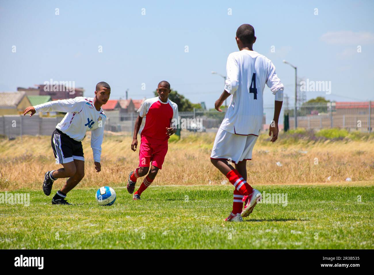 Diverse children playing soccer football at school Stock Photo Alamy