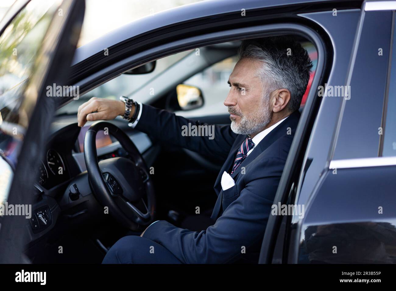 Businessman grey suit sitting hi-res stock photography and images - Alamy