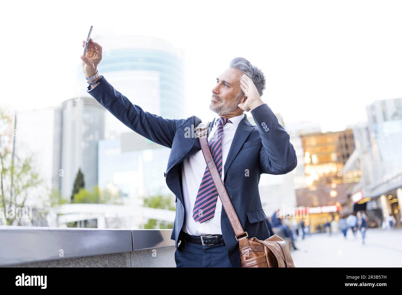 Business saluting and taking selfie through smart phone Stock Photo