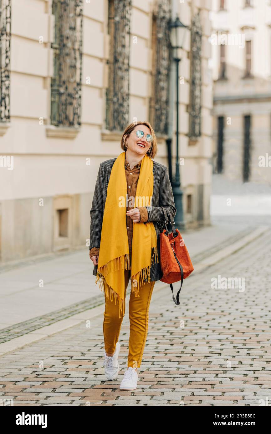 Mature woman walking on street hi-res stock photography and images - Alamy