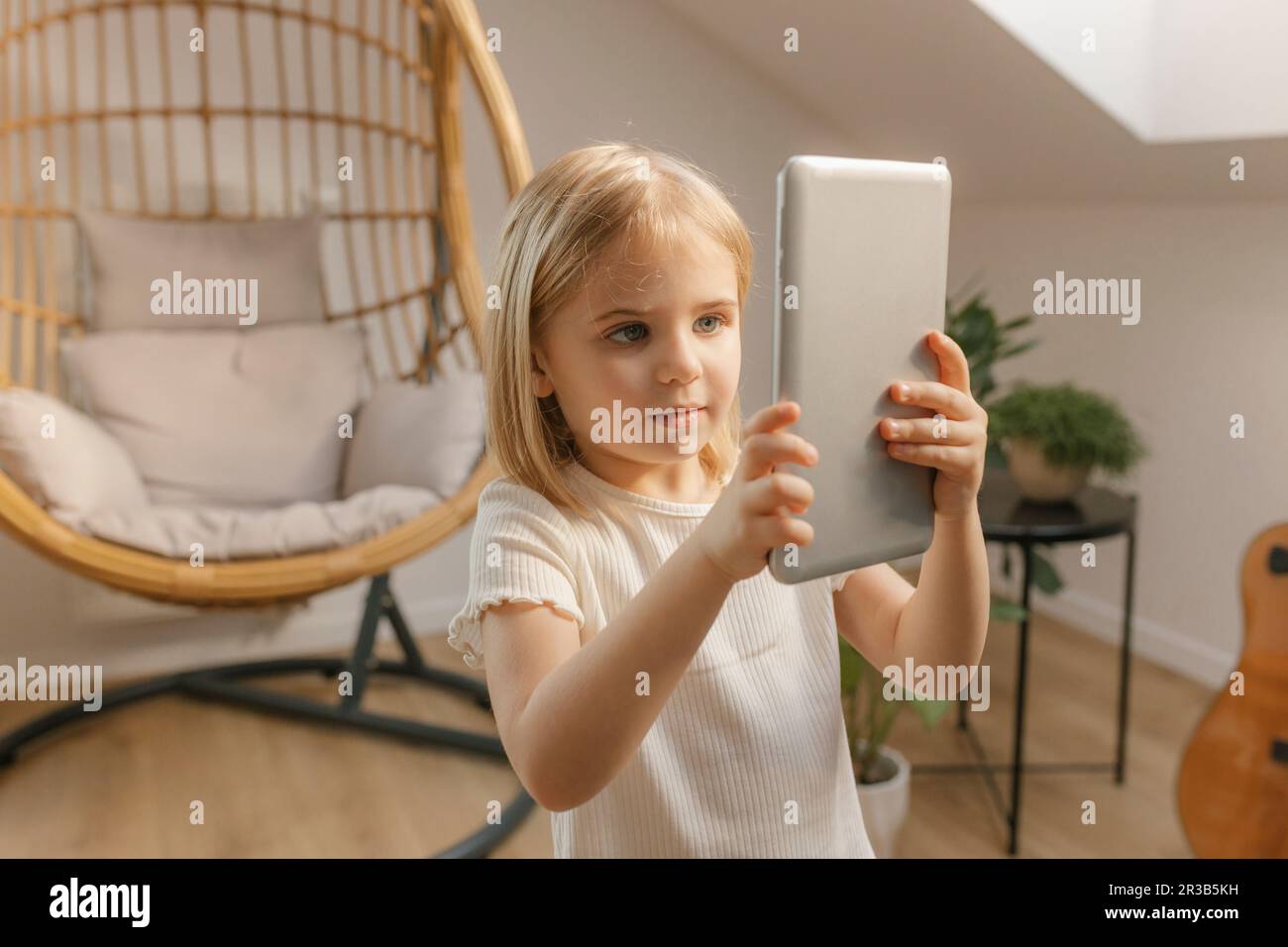 Girl holding tablet PC at home Stock Photo