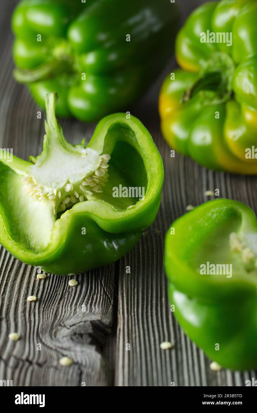 Sweet green pepper on wooden background. Fresh yellow green bell pepper (capsicum) Stock Photo