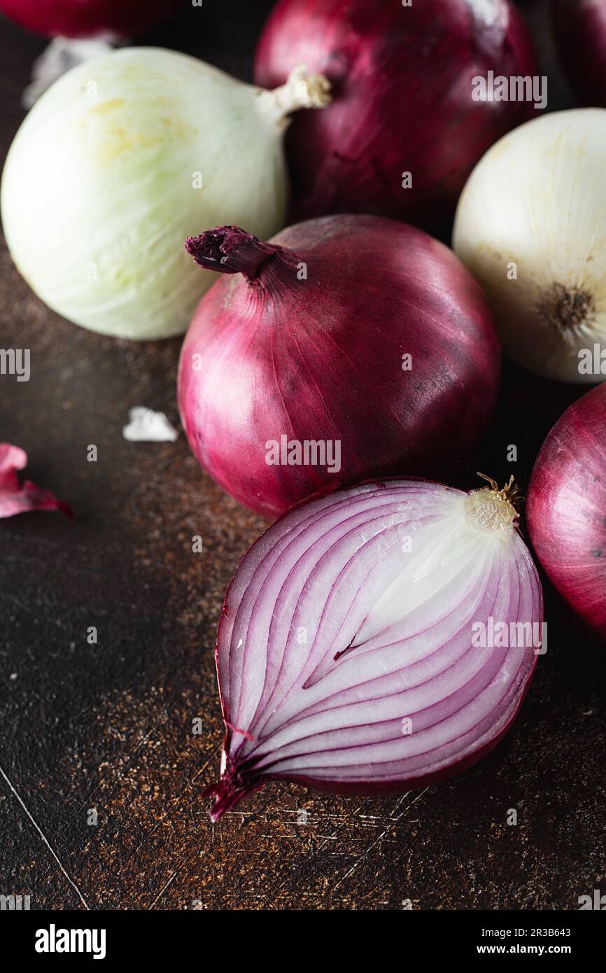 Red onions on dark background. Red onion halves. Food Ingredients Stock Photo