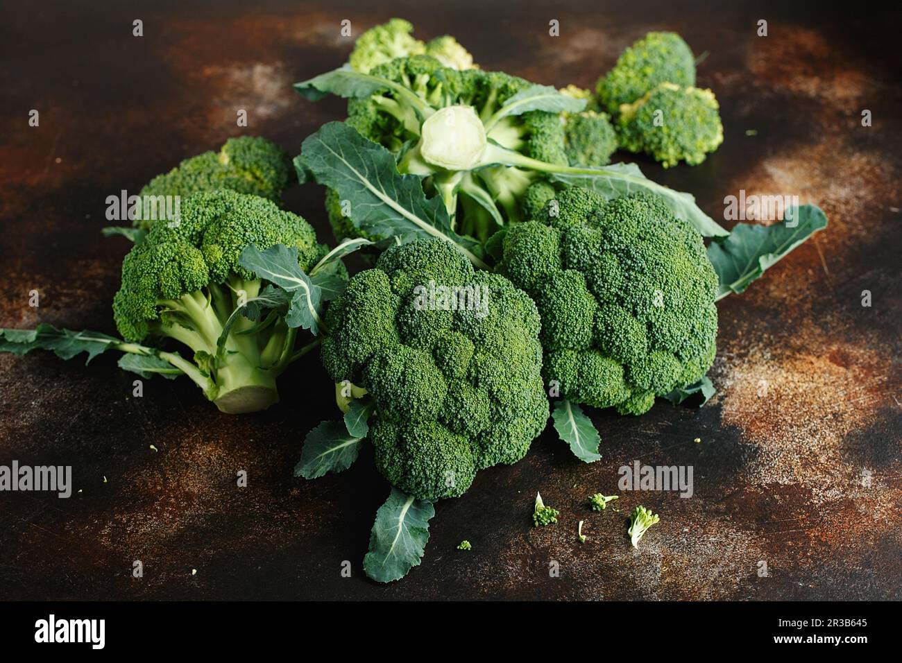 Fresh green broccoli on a dark brown background. Macro photo green fresh vegetable broccoli. Green V Stock Photo