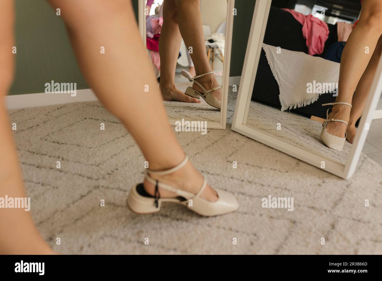 Woman trying heels standing near mirror at home Stock Photo
