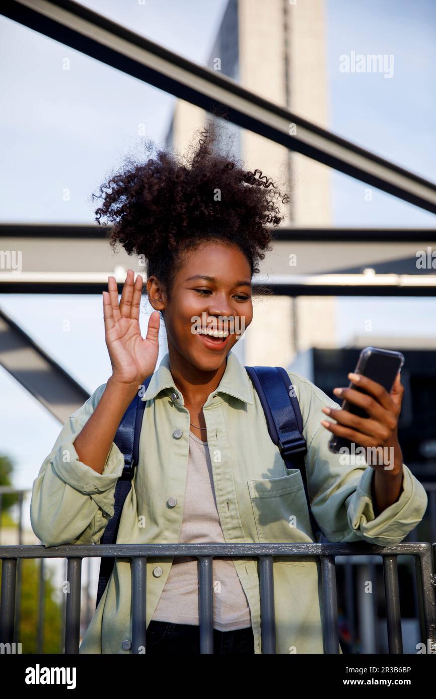 Happy woman waving on video call through mobile phone Stock Photo - Alamy