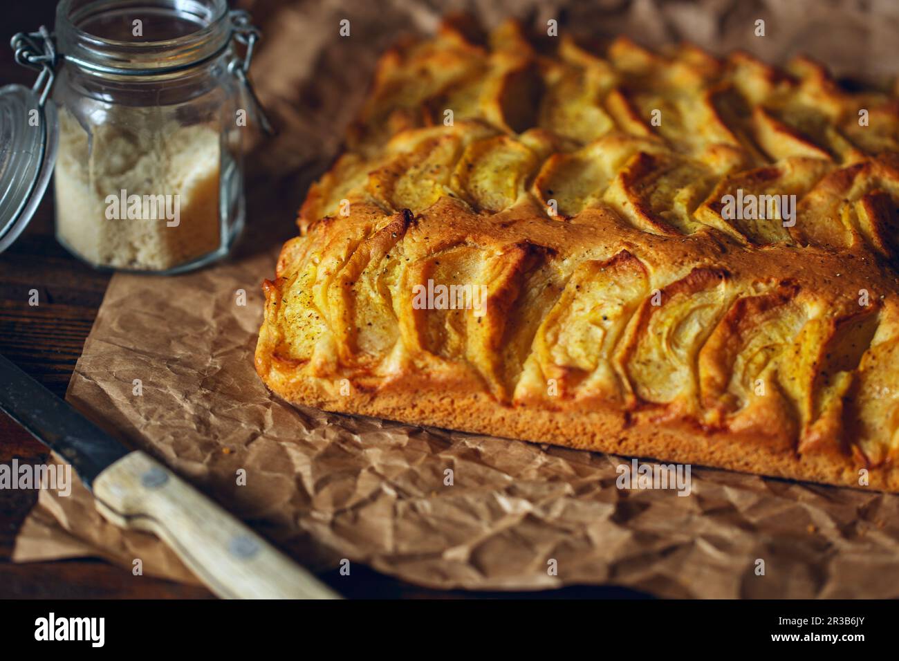 Homemade rustic apple pie on a wooden old vintage table. Dark background. Seasonal bakery concept. A Stock Photo