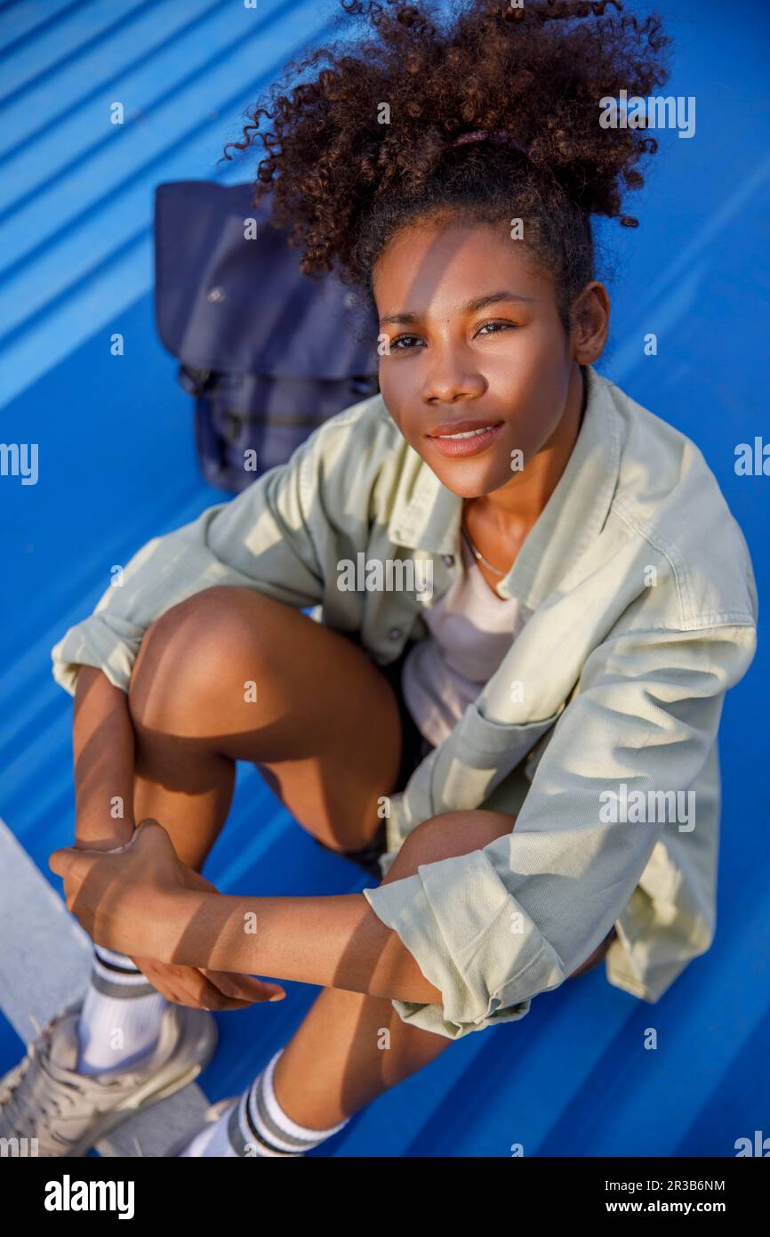 Young woman sitting on floor Stock Photo