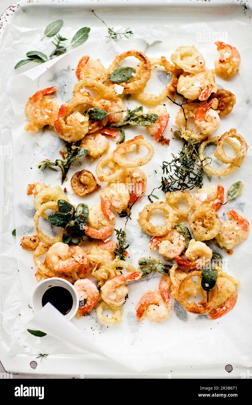Fried seafood and onion rings in tempura batter with sage leaves Stock
